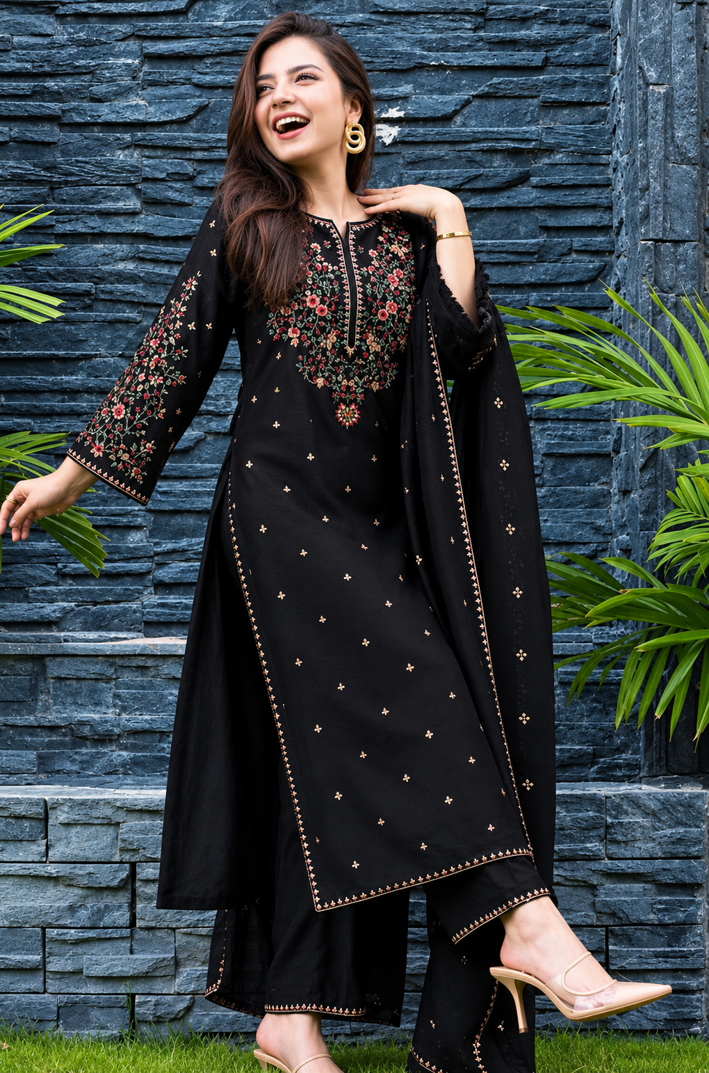 Model wearing a black embroidered RAQS suit